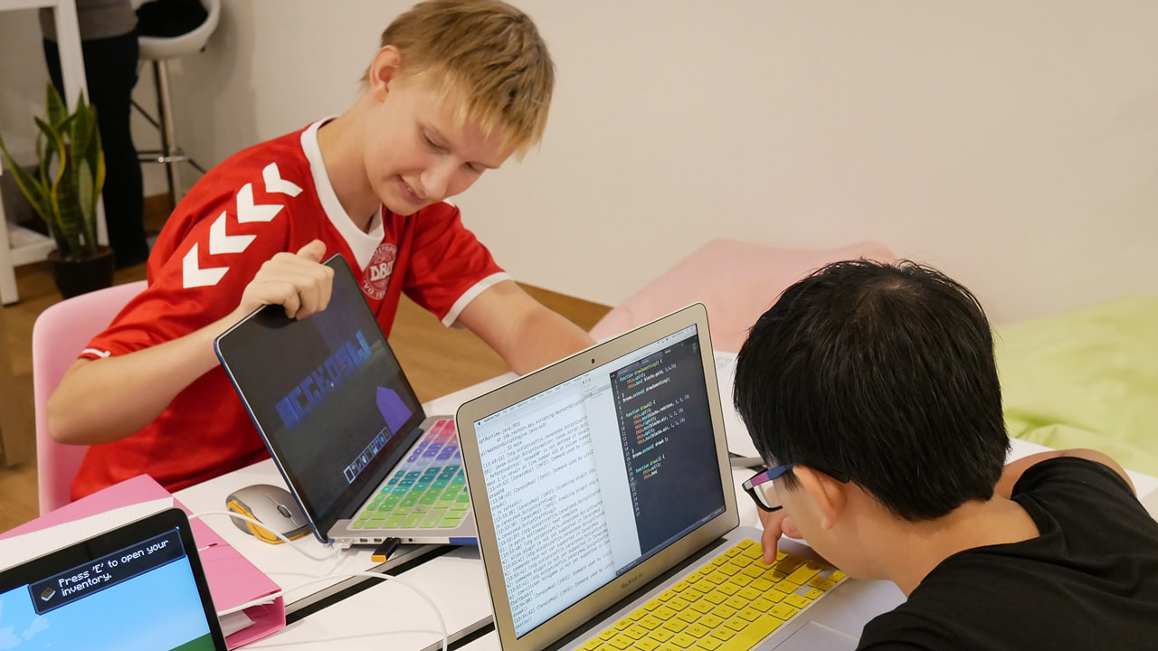 Older LCCL students writing real Python on their laptops